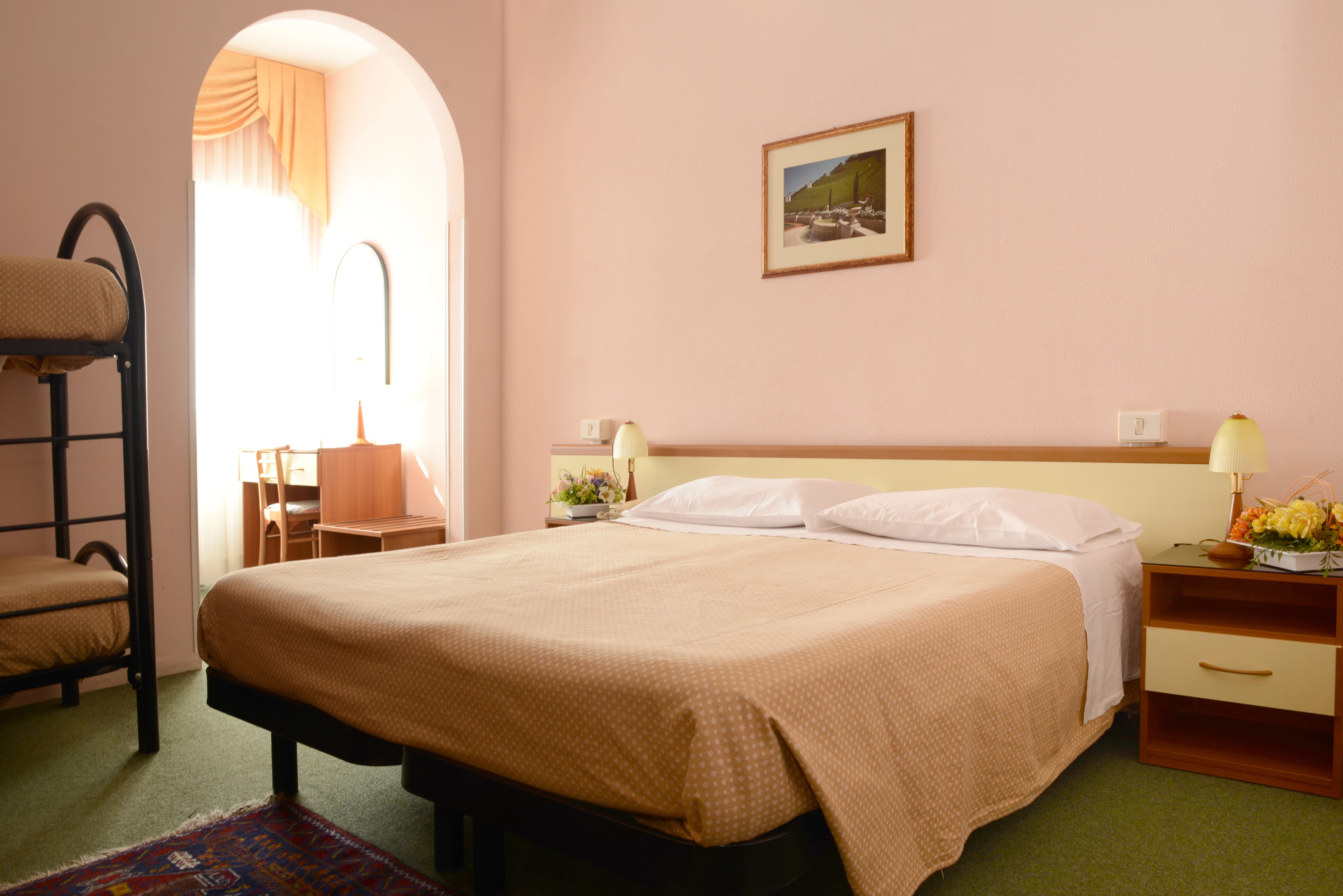 Family guest room with double bed and workspace at the Bahá’í Study Center for business travel