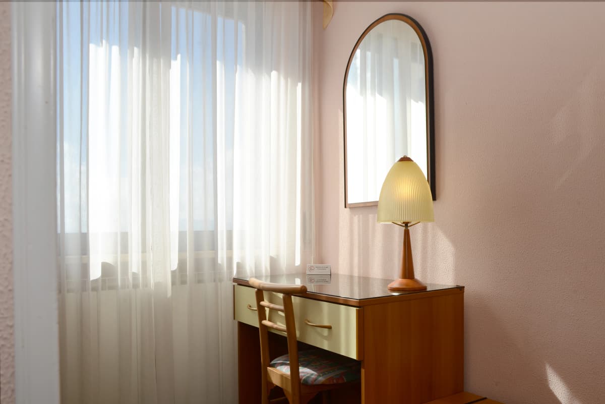 Guest room workspace with natural light at the Bahá’í Study Center for business guests